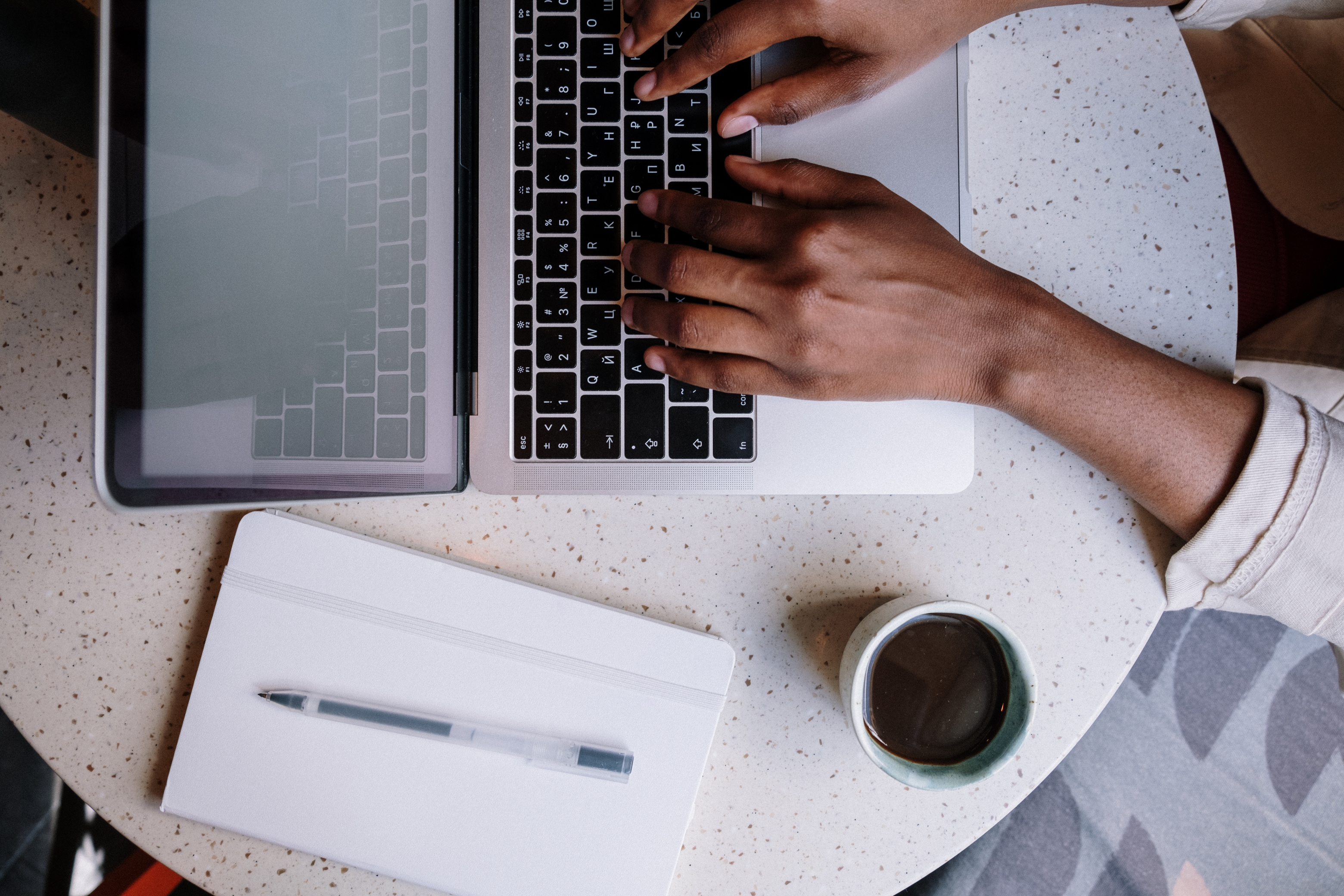 Person Using Macbook Pro on White Table